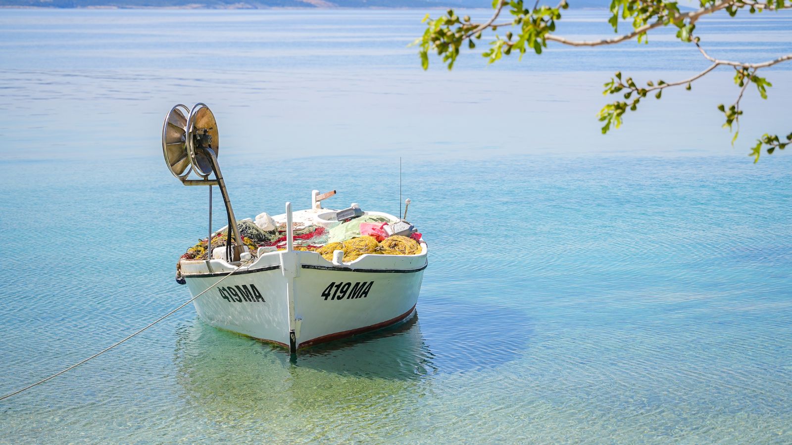 Old white wooden boat at the sea on the Makarska Riviera, oko baške vode