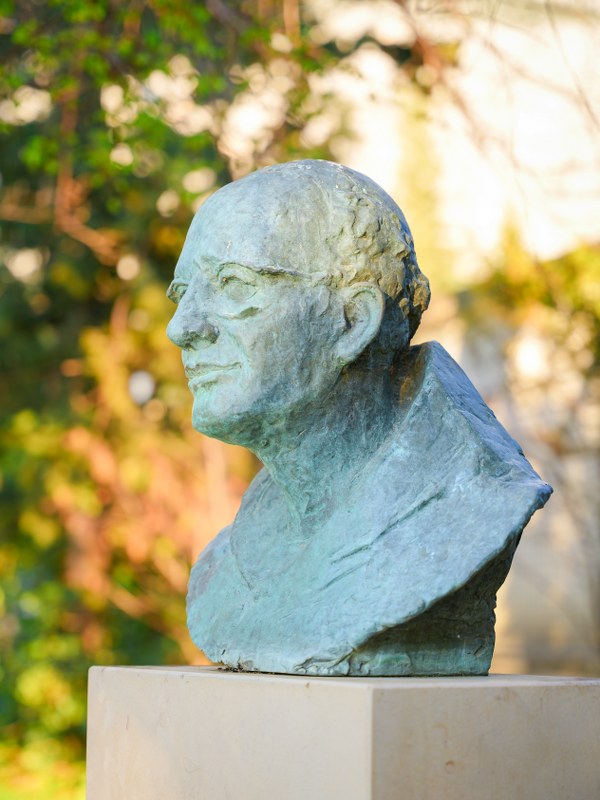 Bronze bust of friar Jure Radić among trees, founder of Kotišina botanical garden