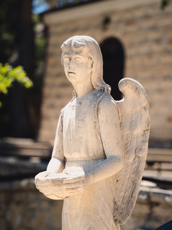 Stone angel statue holding a shell at the Vepric shrine