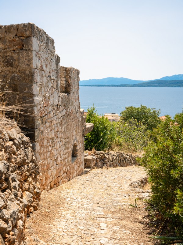 Stone steps winding past old houses in Igrane