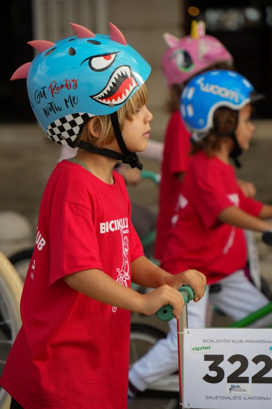 Children in helmets at the Biciklijada cycling event in Makarska
