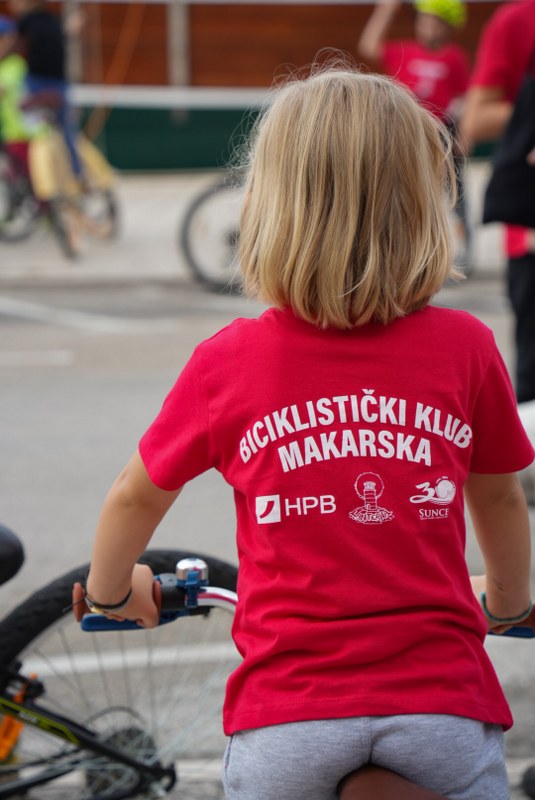 Child wearing a Biciklijada Makarska cycling club jersey