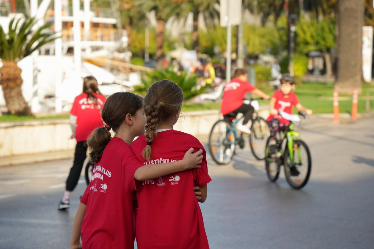 Cyclists in red jerseys at the Biciklijada event in Makarska